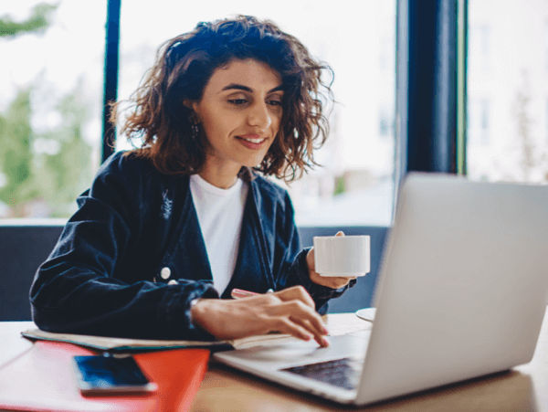Person using TotalAV&trade; in a coffee shop